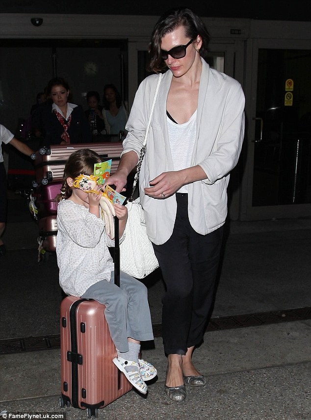 Milla Jovovich looked radiant breezing through LAX with daughter Ever