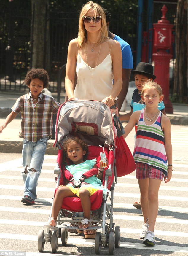 Heidi looks glum as she goes for a stroll with her children and Seal’s brother