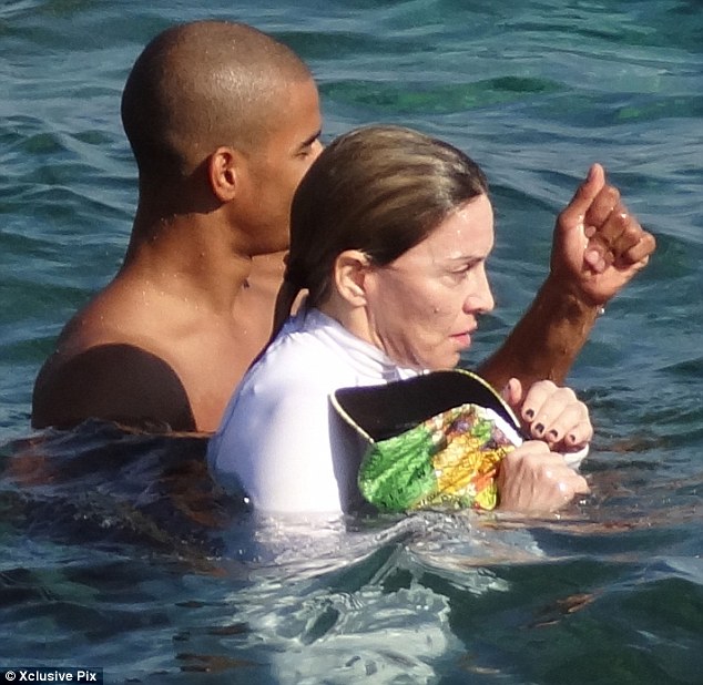 Madonna covers up for a dip in the French Riviera