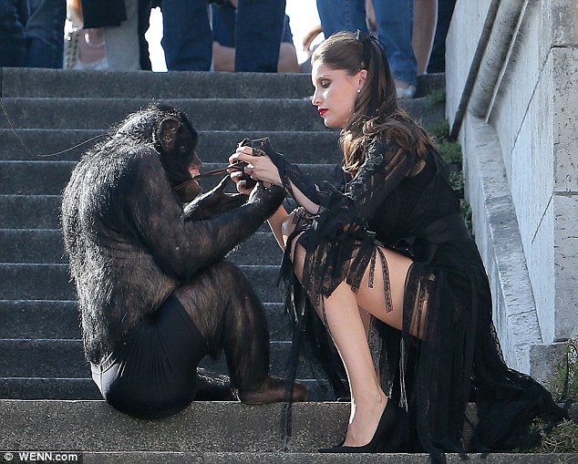 Model Laetitia Casta monkeys around with chimp on photoshoot