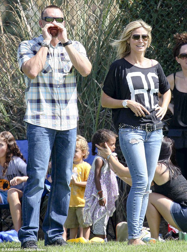 Supermodel Heidi Klum shows off her washboard abs at sons football practice