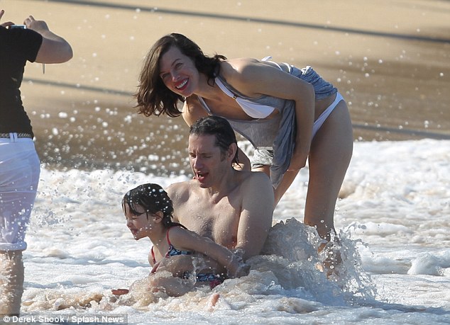 Milla Jovovich vamps it up on the beach
