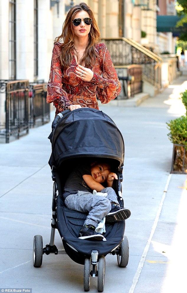 Miranda Kerr takes a stroll with son Flynn looking  a bit overdressed