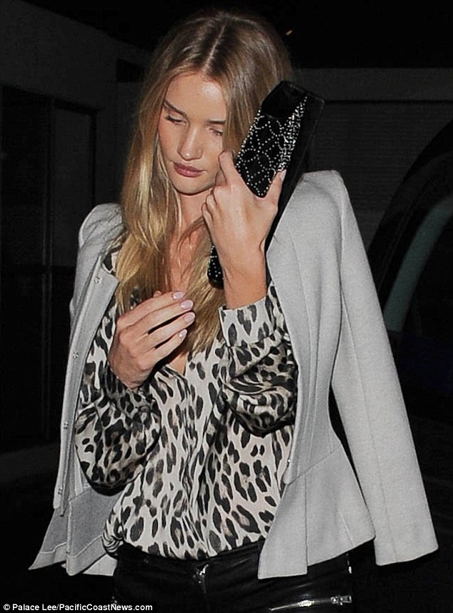 Rosie Huntington-Whiteley looks down and out as she returns to a lonely hotel room
