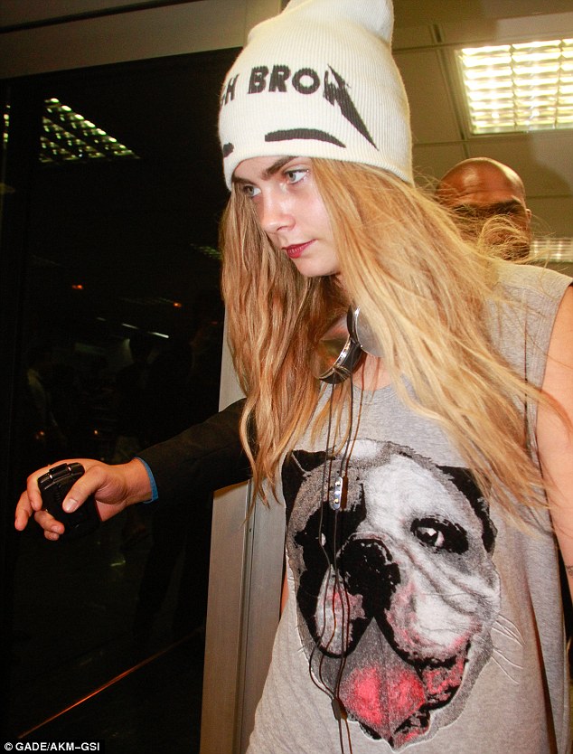 Cara Delevingne arrives in Rio, Brazil red-eyed and tired